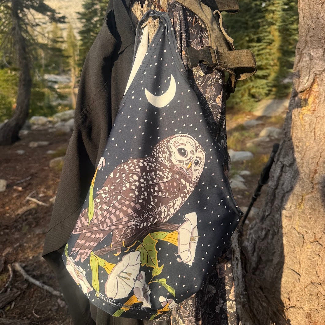 crop top drying on a tree stump after a swim in a backcountry lake