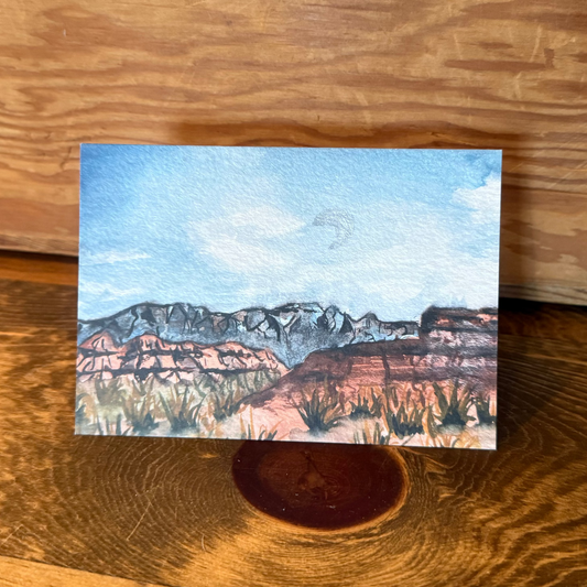 Small landscape painting of Zion National Park on a wooden surface